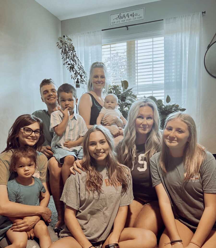 Single mom takes family picture with grown adult children and grandbabies.