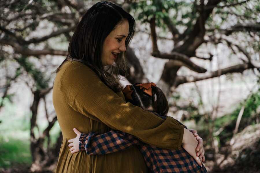 mother embraces her daughter