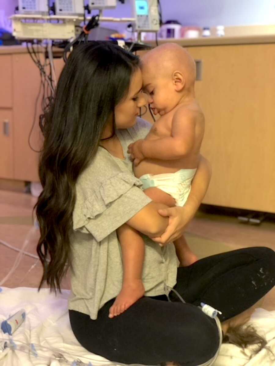 mom holds her son while they are in the hospital
