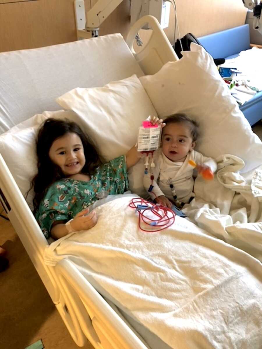 little sister holds the bag containing her bone marrow she donated to her brother