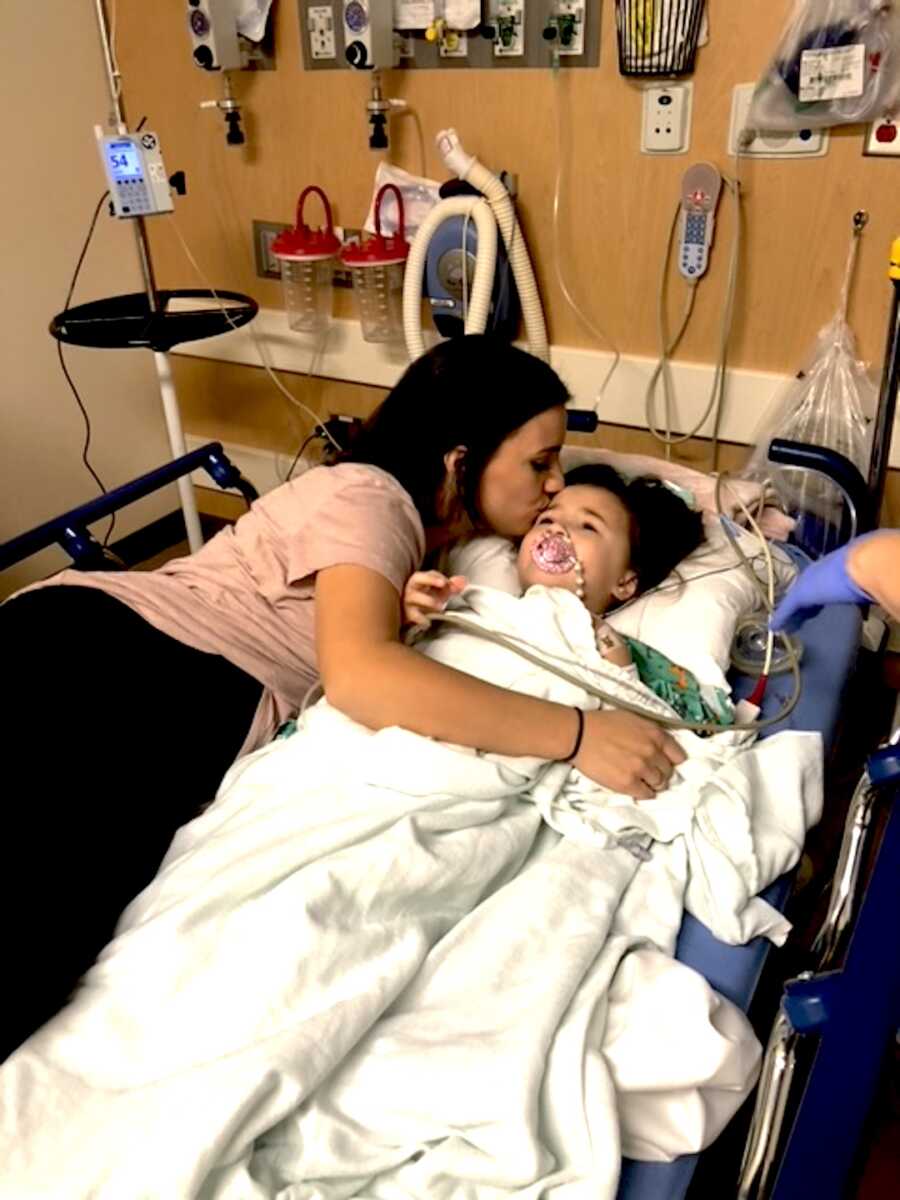 mom holds her daughter after her bone marrow extraction