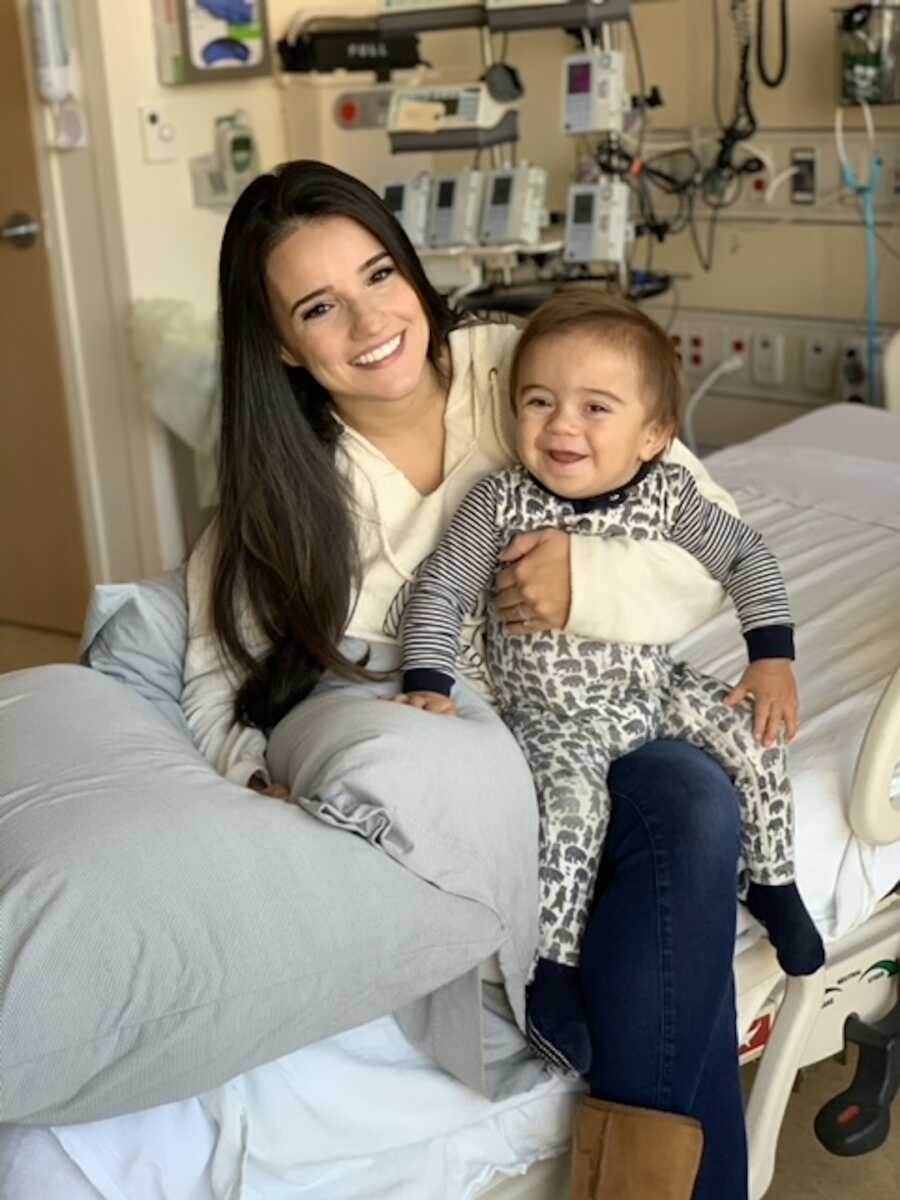 mom holds her son on her lap at the hospital