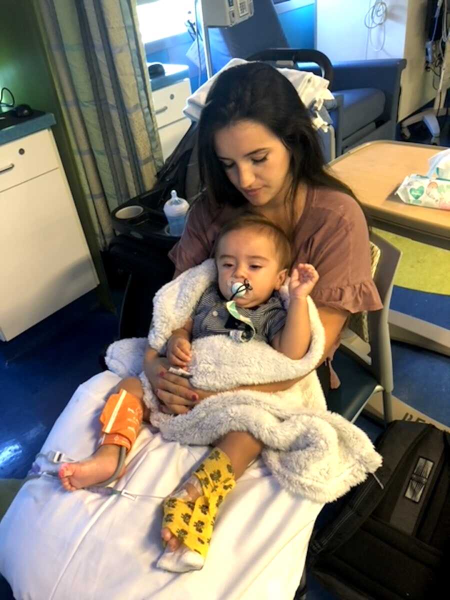 mom holds her son in her lap at the hospital