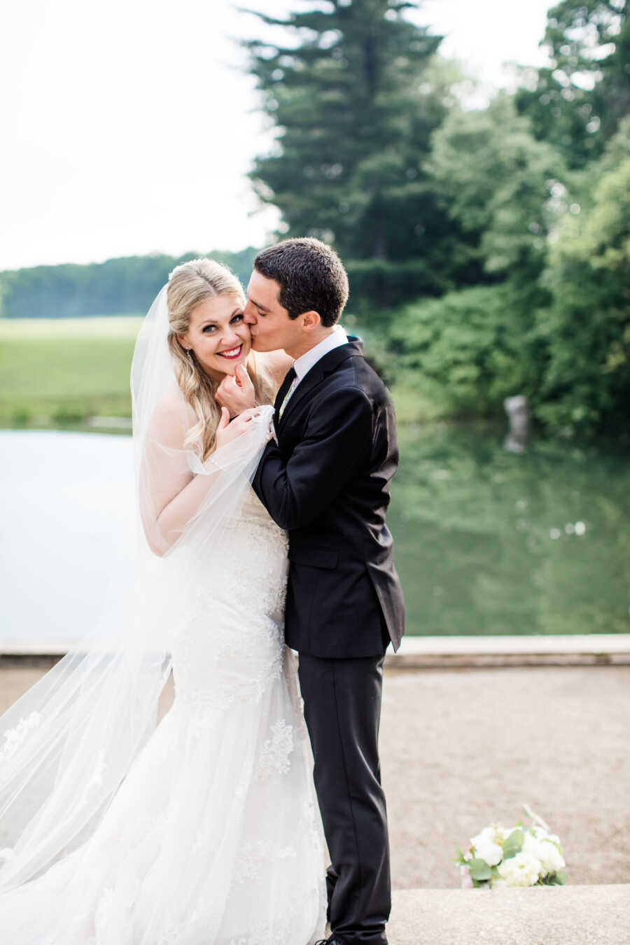 husband gives his wife a kiss on the cheek