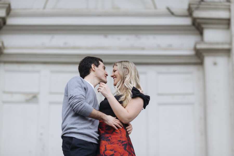 husband holds onto wife while they look into each other's eyes