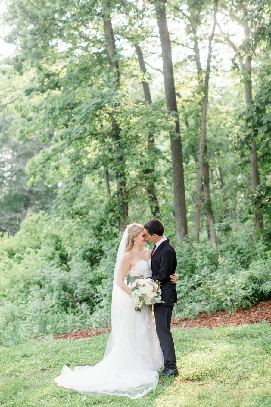 husband and wife embrace one another on their wedding day