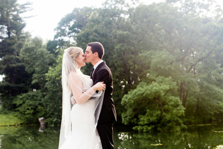 husband gives his wife a kiss on the nose on their wedding day