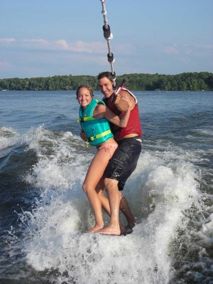 Couple water ski together on the lake.