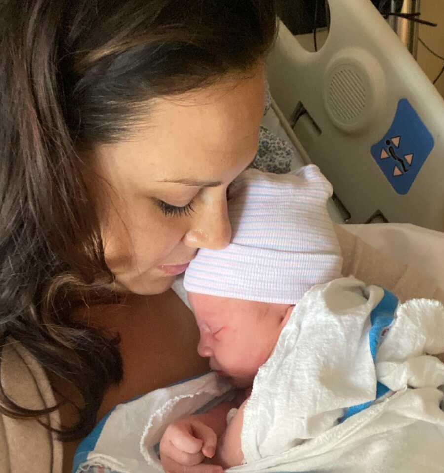 Mom holding her baby boy in hospital bed