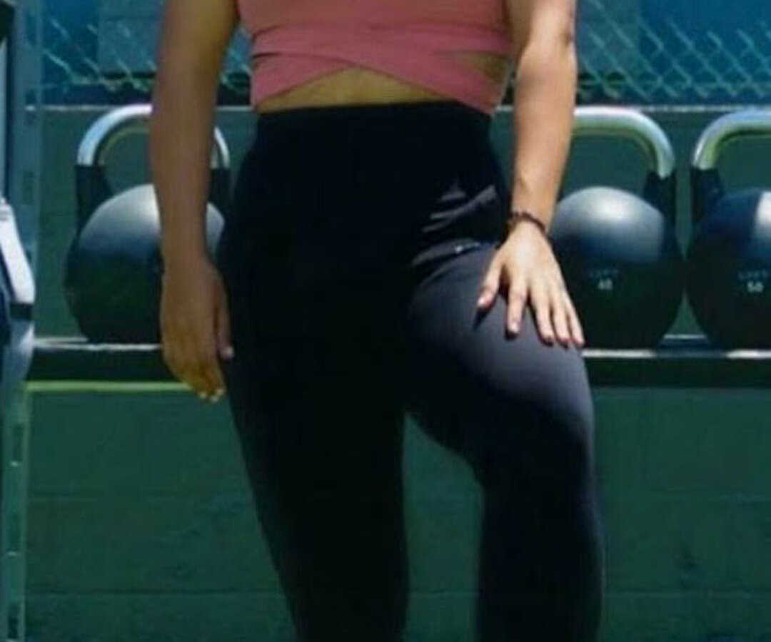 woman standing at gym smiling