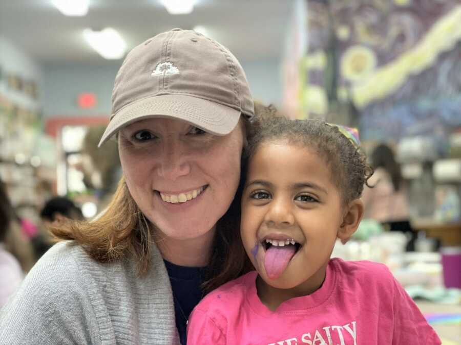 Single adoptive mom and daughter take selfie together.