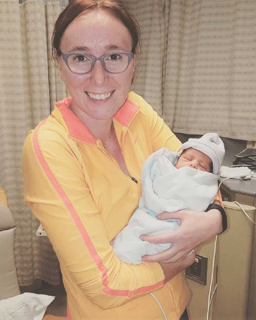 Single woman holds new baby entering foster care.