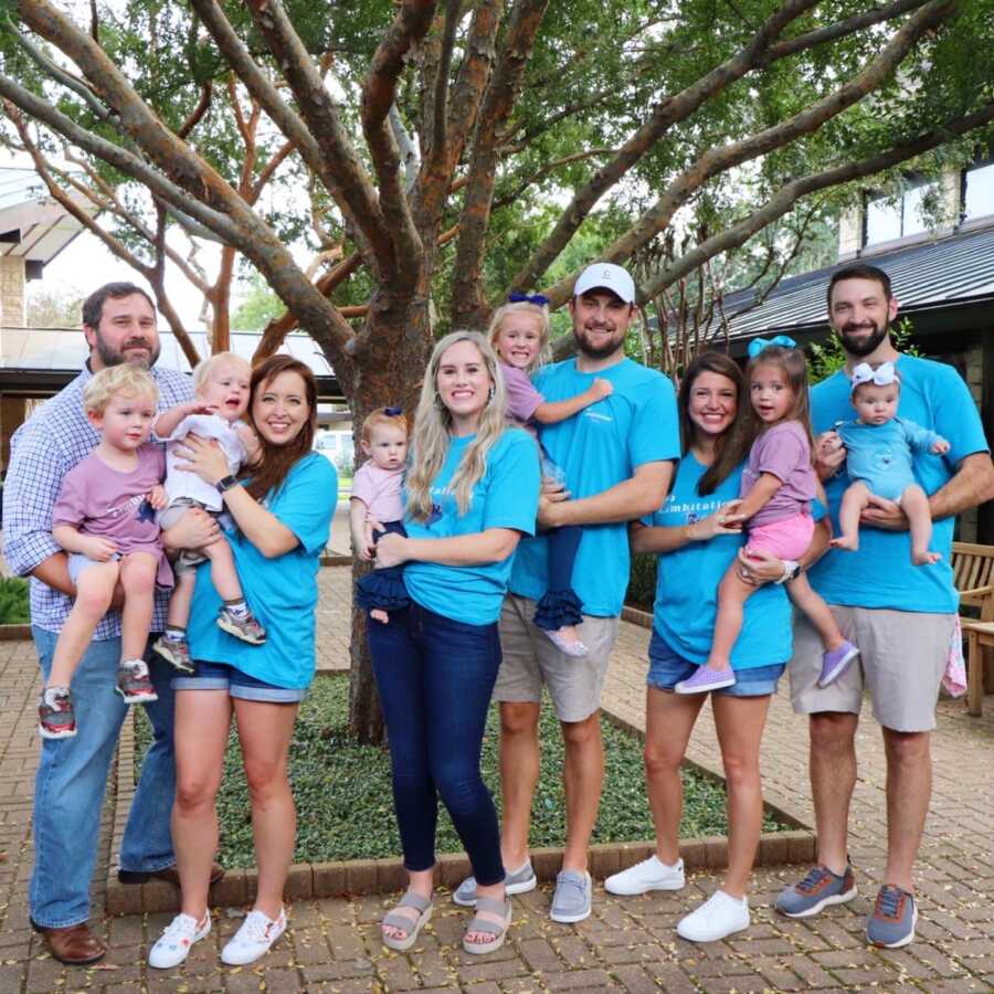 Three families of children with limb differences take picture together.