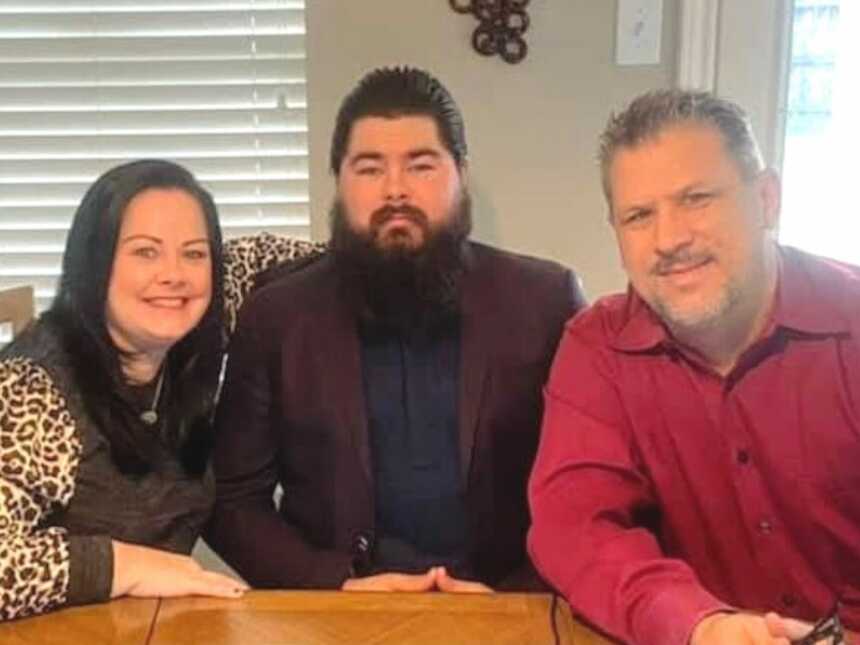 Parents sit next to their son at his virtual adoption