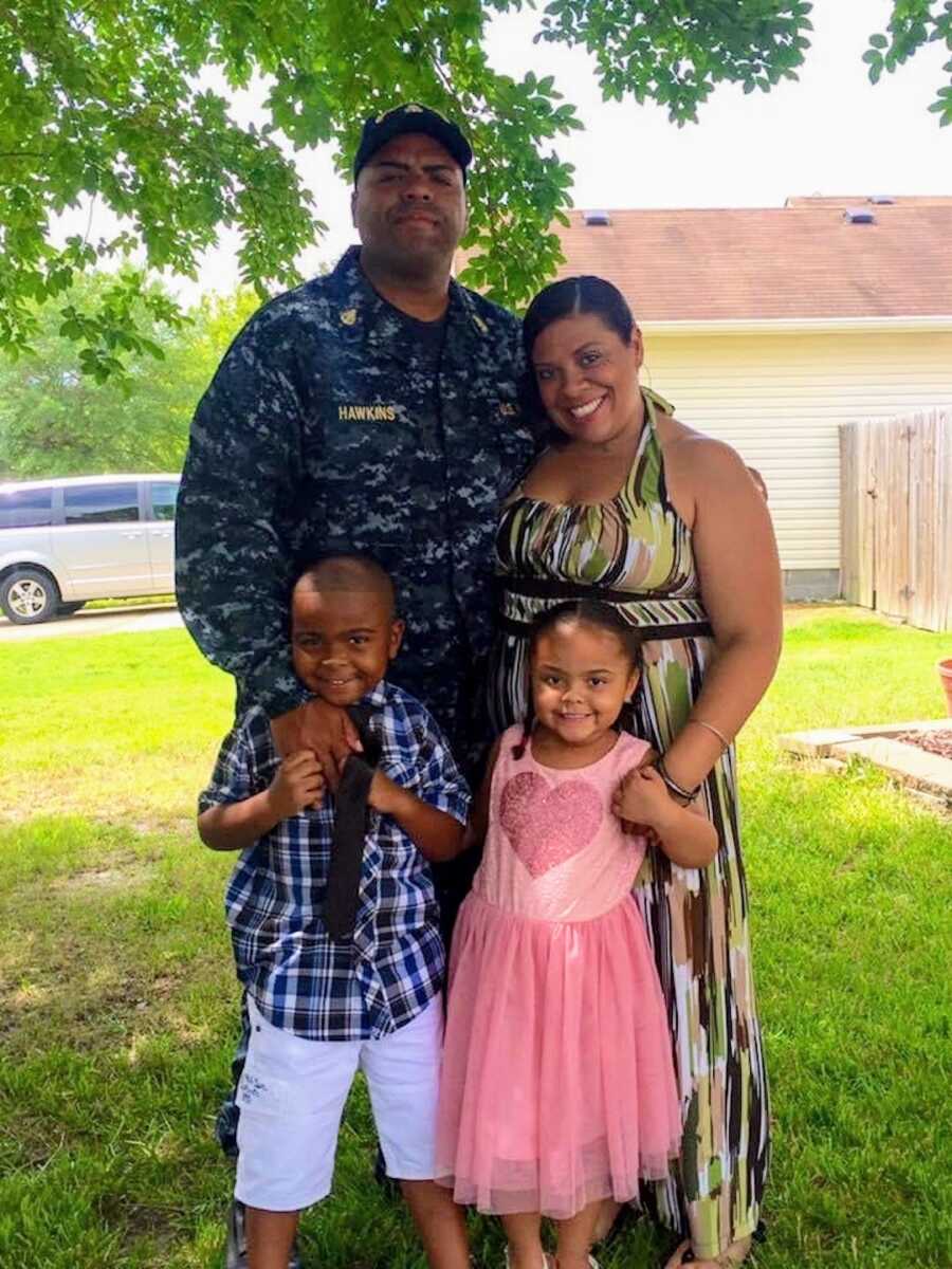 military family stands with their dad/husband while he is in uniform