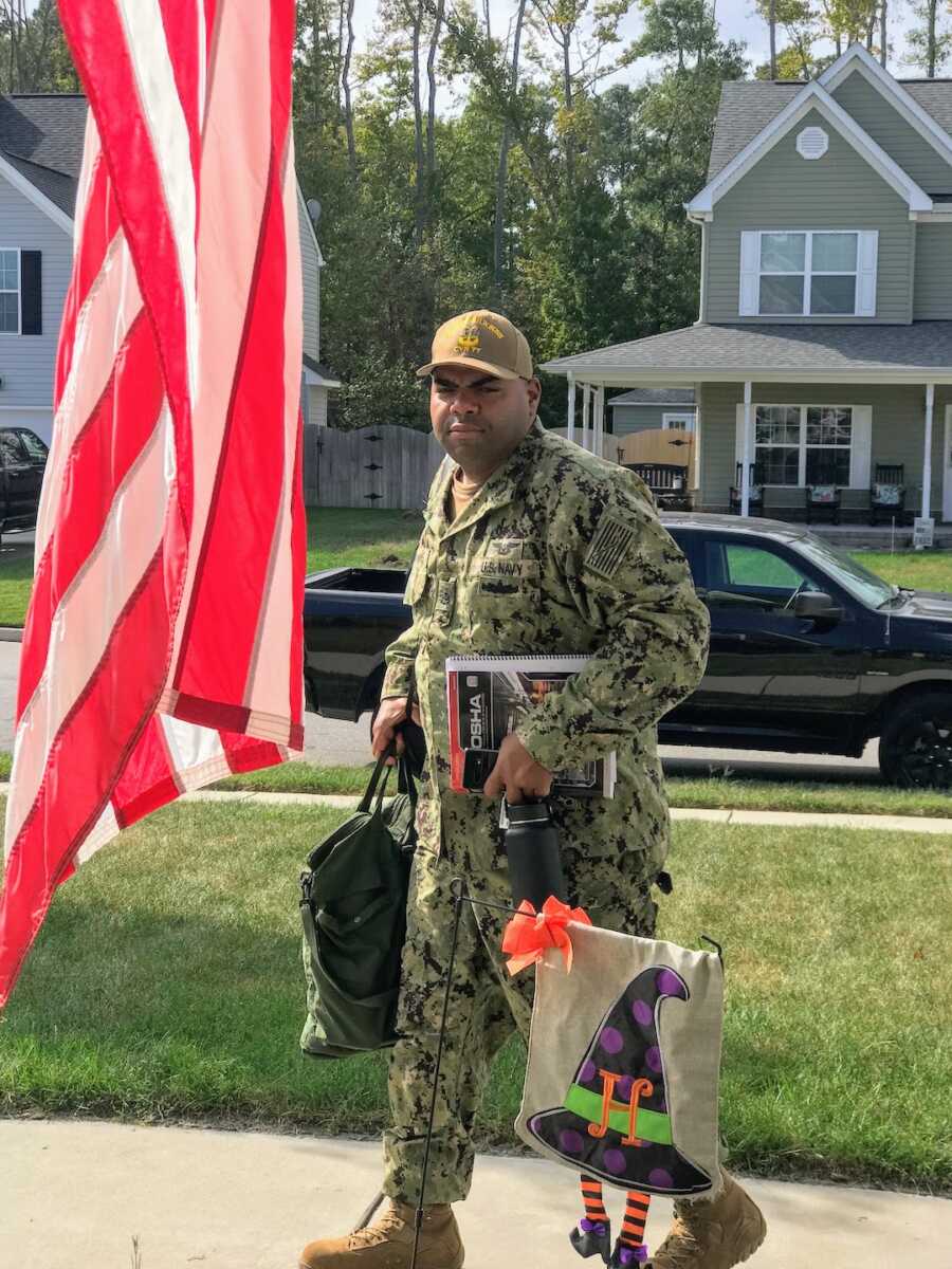 navy seal returning home with belongings in his hands