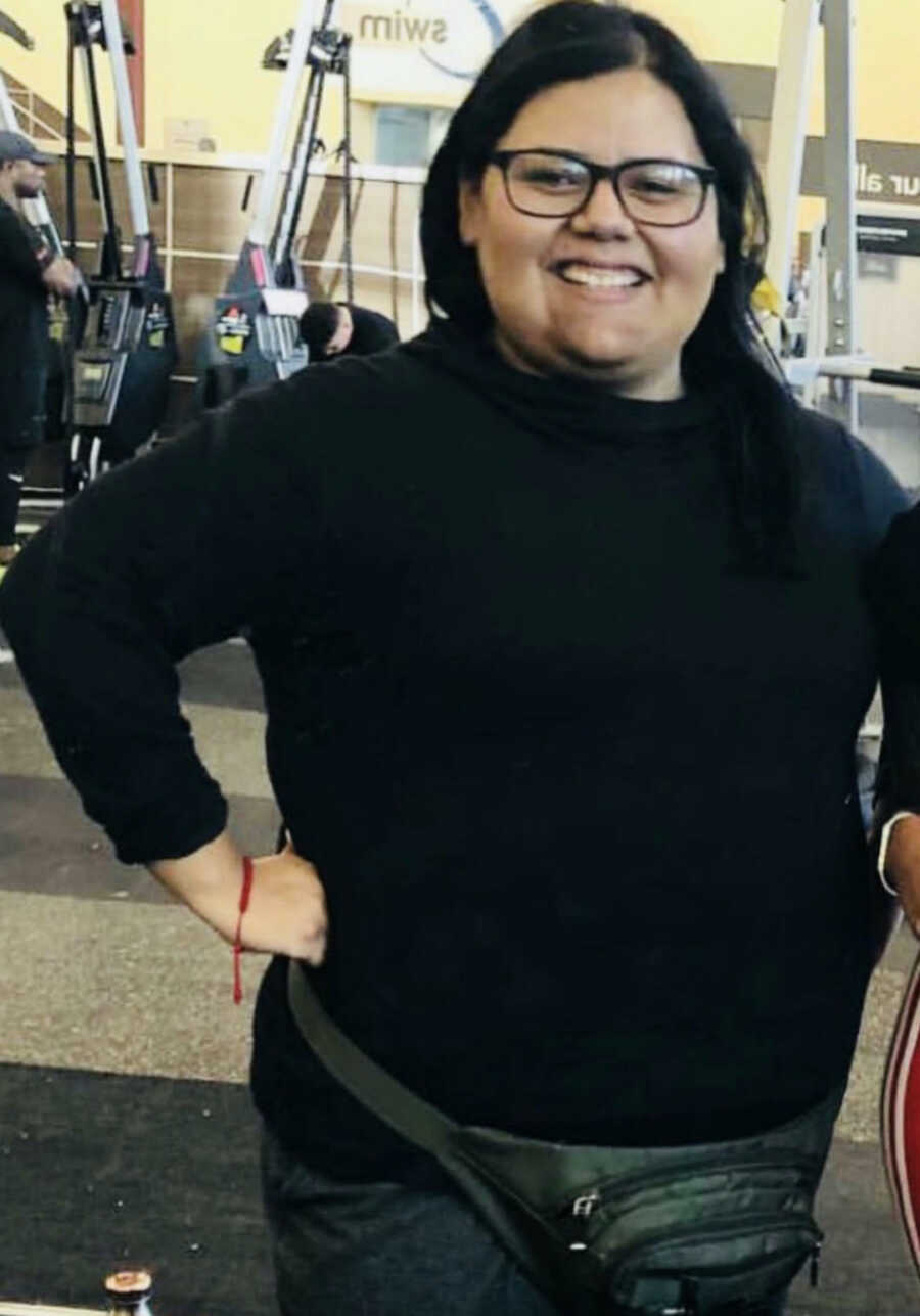 Woman standing smiling at gym 