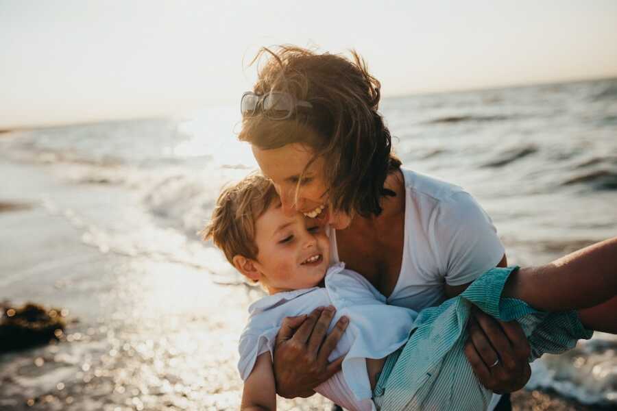 mother holds her son close to her