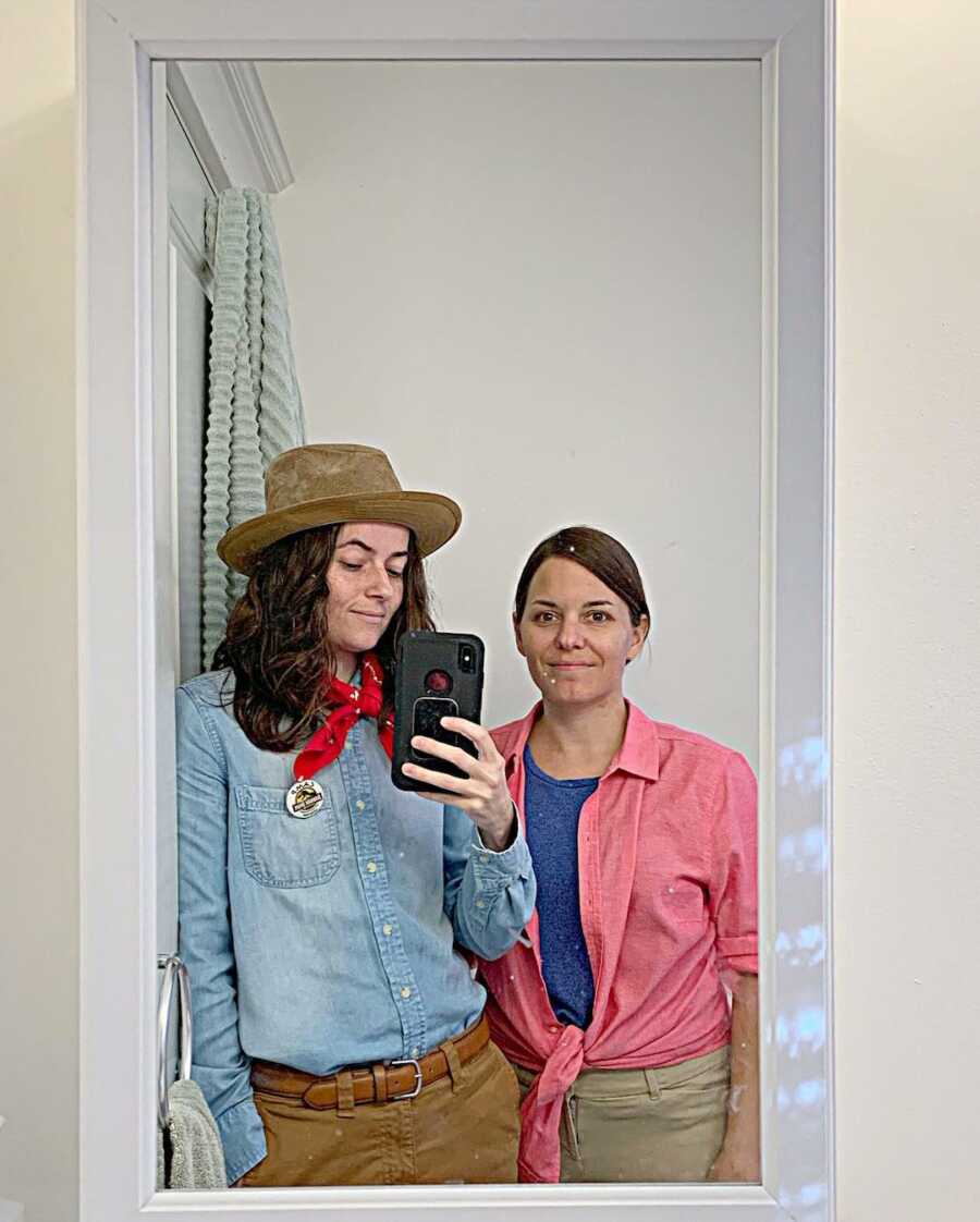 woman dressed as a cowboy with her partner in mirror
