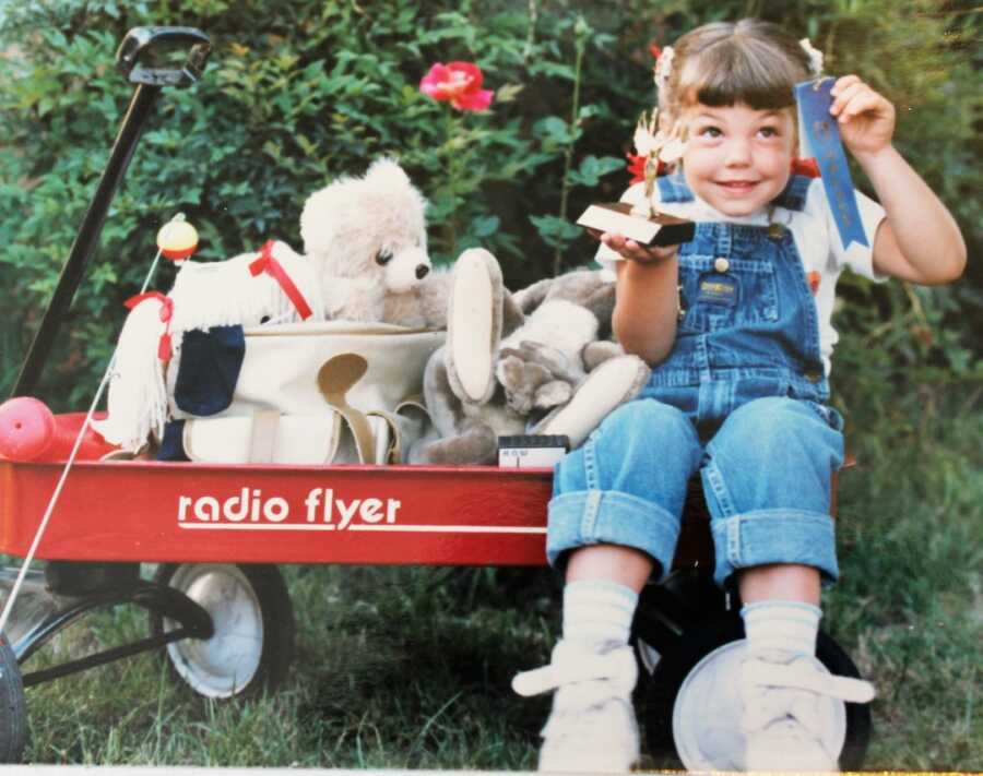 little girl in red wagon