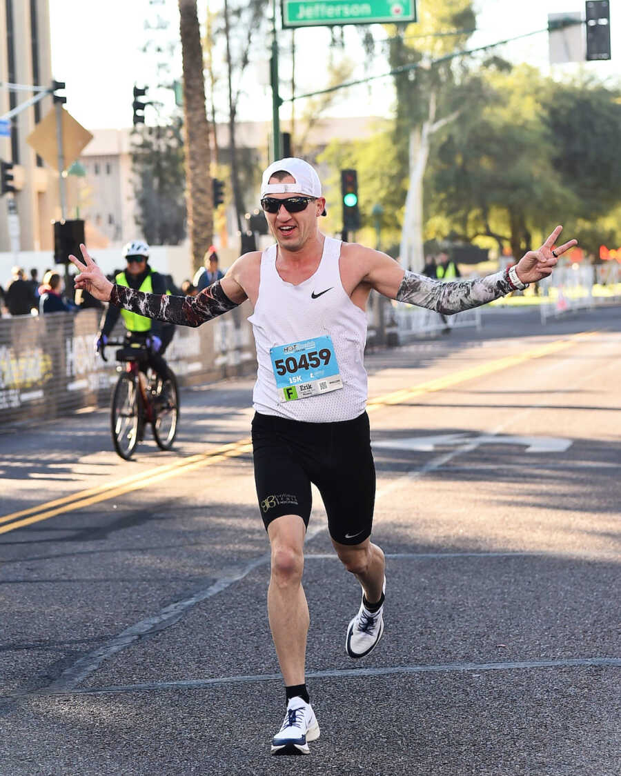 man running in white tank top