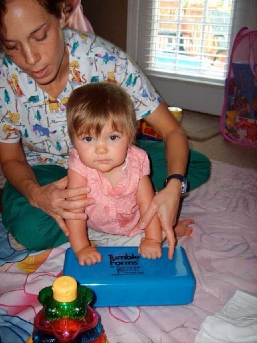 little girl with parent behind her 