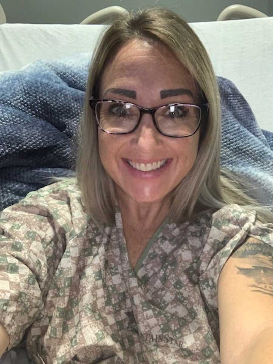 woman taking selfie in hospital bed 