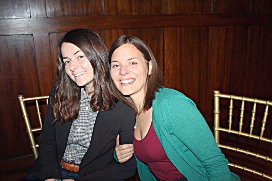 two women sitting smiling 