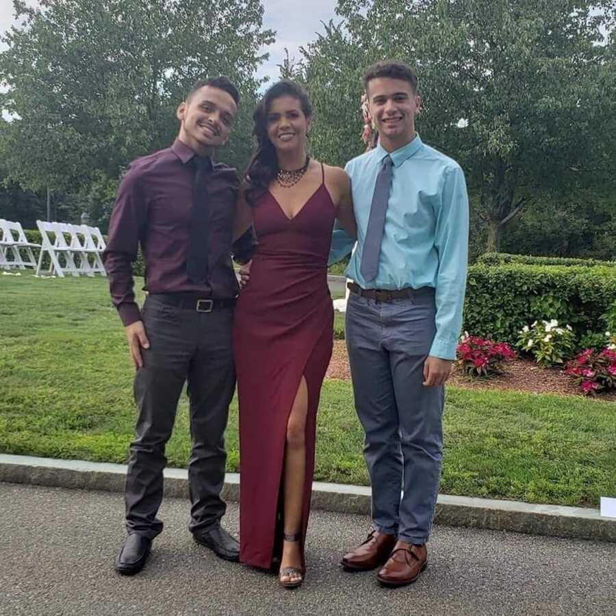 mother standing with two sons dressed up 