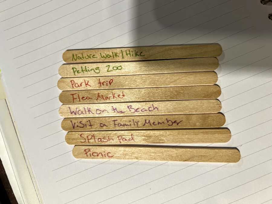 Mom writes outdoor activities to do over summer on sticks for her kids to "pick a stick"