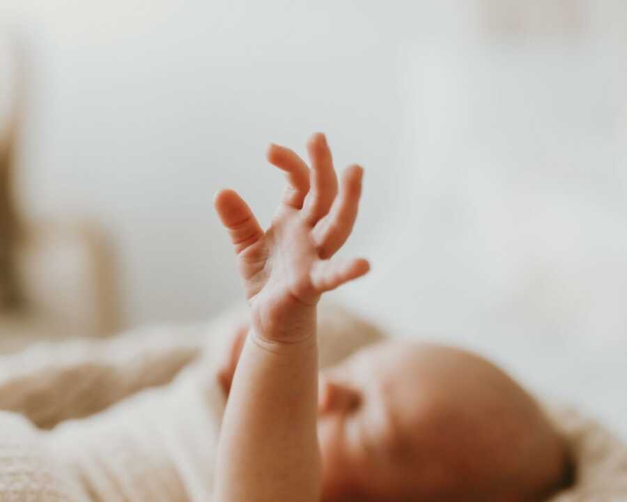 baby reaching his hand out
