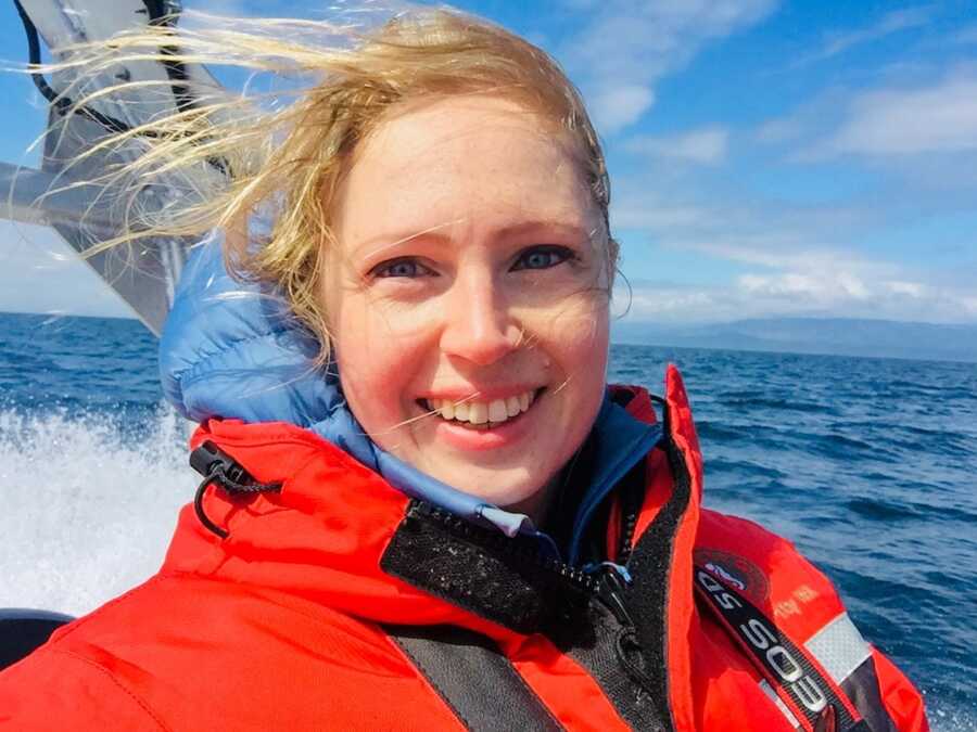 woman on a boat smiling 