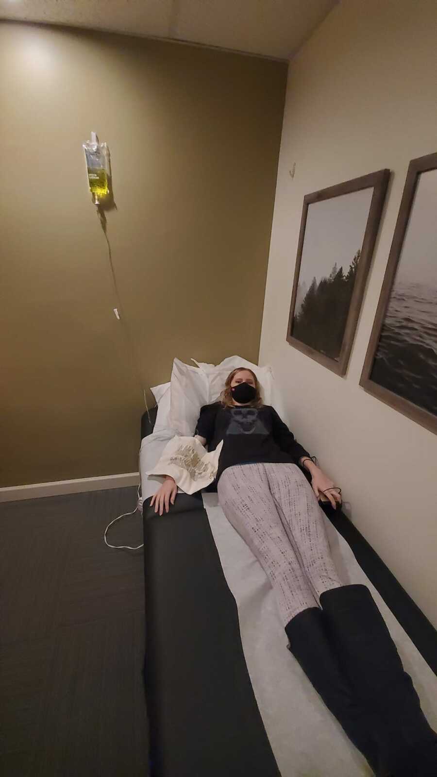 woman lying down on bed at doctors 