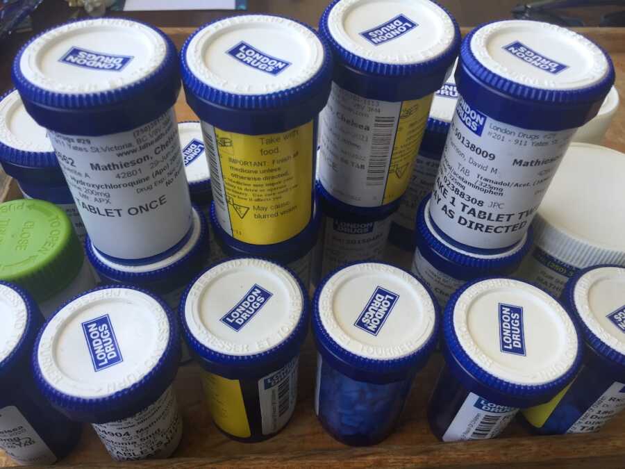 medicine bottles stacked up on table