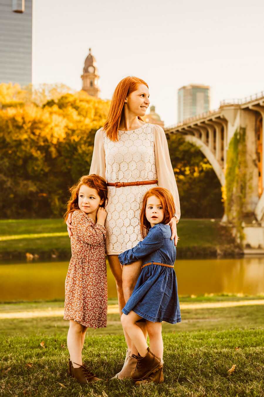 mom holding her two daughters close