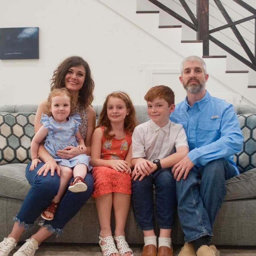 family photo on couch with parents and children