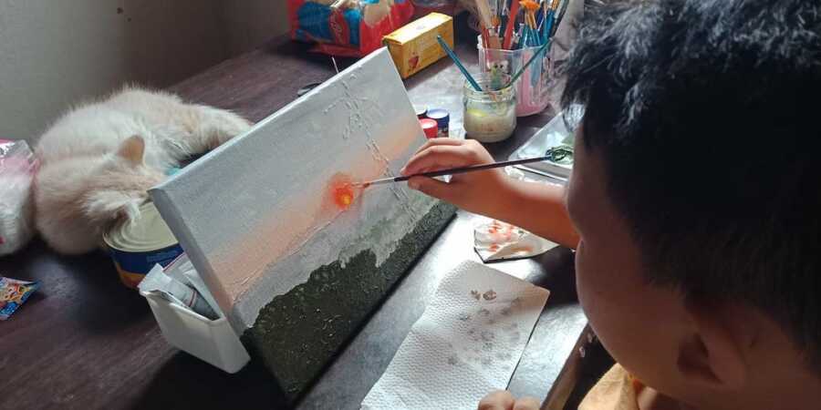 little boy painting 