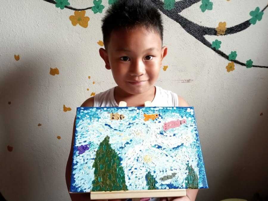 little boy with painting 