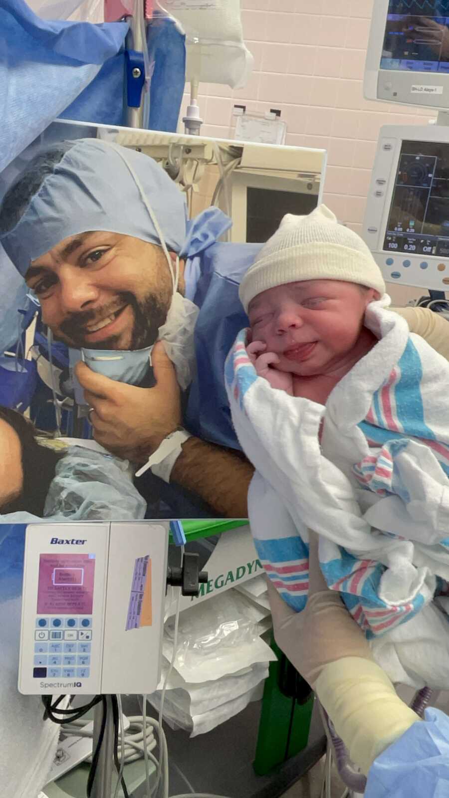 son being held up with a picture of his father