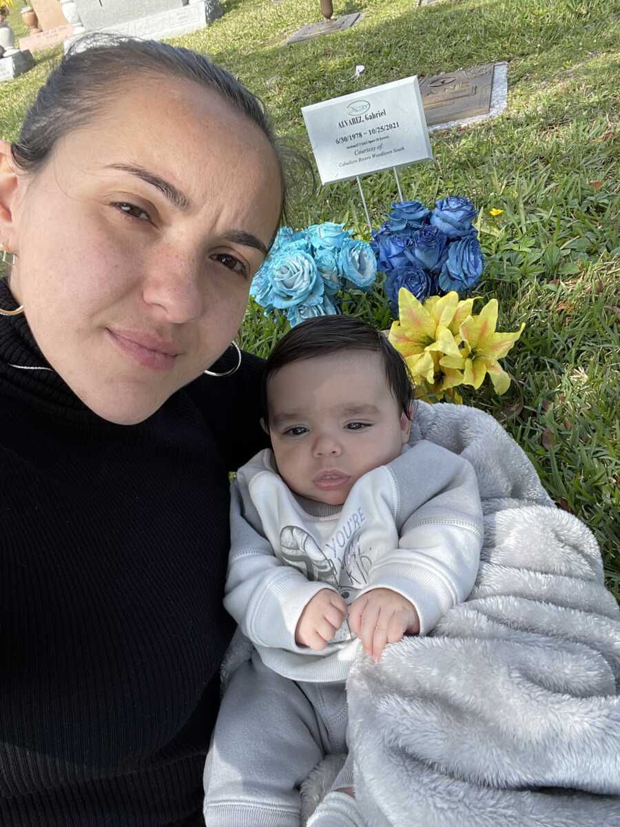 woman with her son at his father's grave