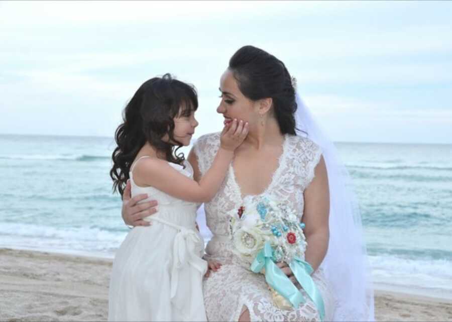 mom and step daughter taking a pic at wedding