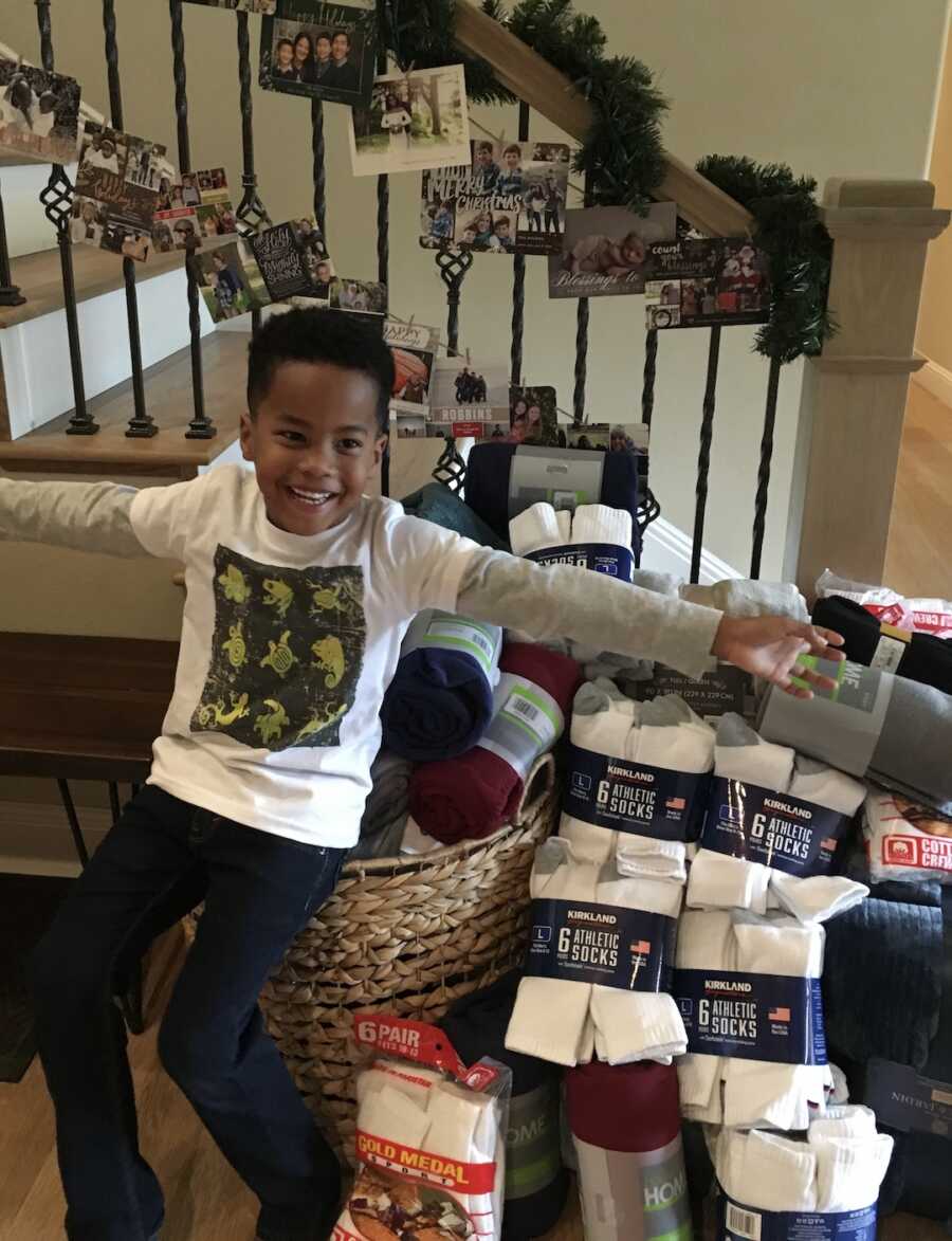 young boy with charity items in back 