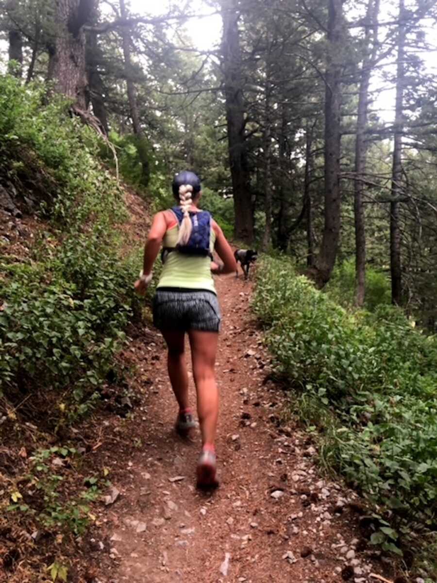 woman running through the forest