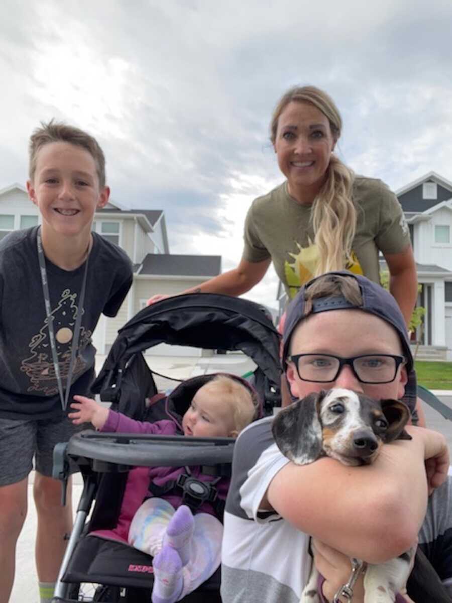 mother with three kids and a dog going for walk 