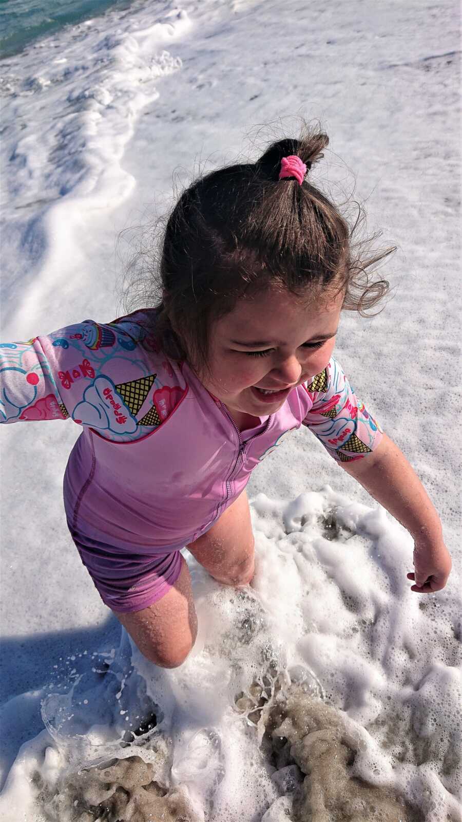 little girl enjoying herself on the beach