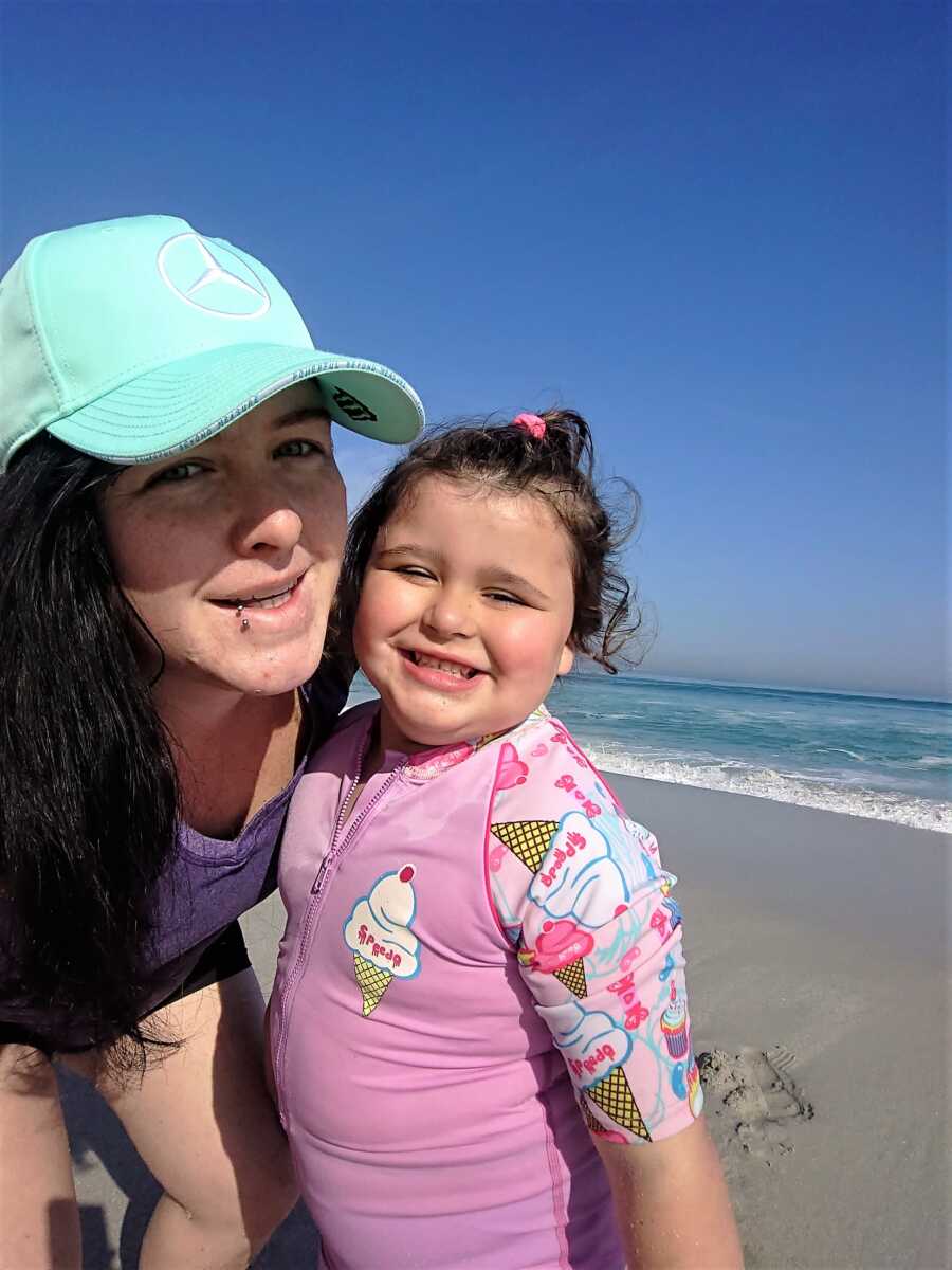 mom taking a selfie on a beach