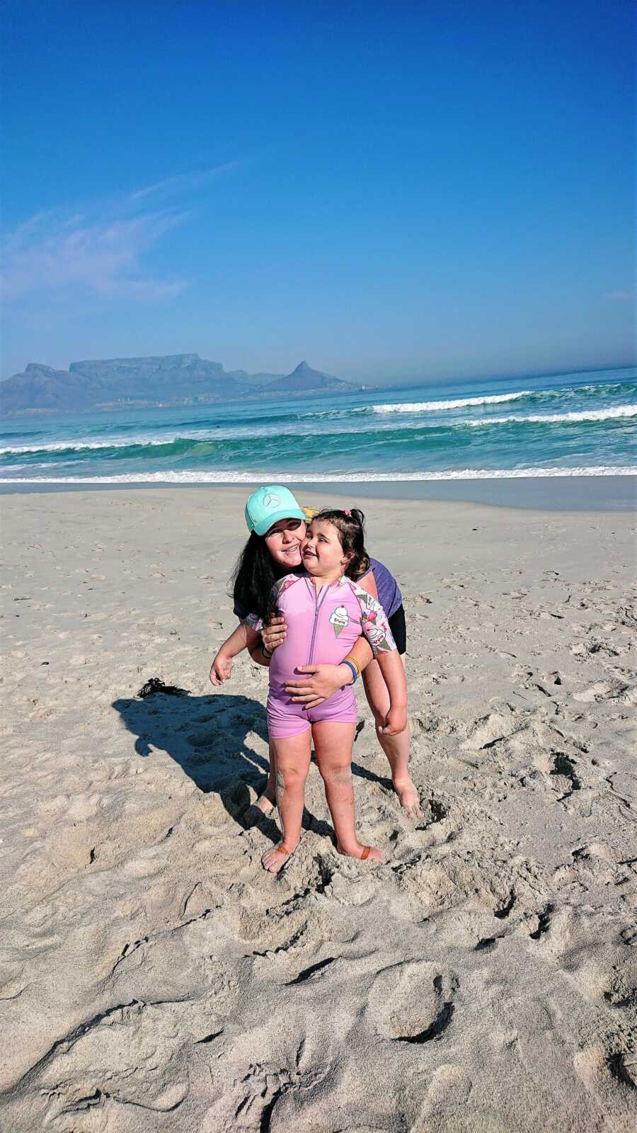 mom and daughter enjoying the beach