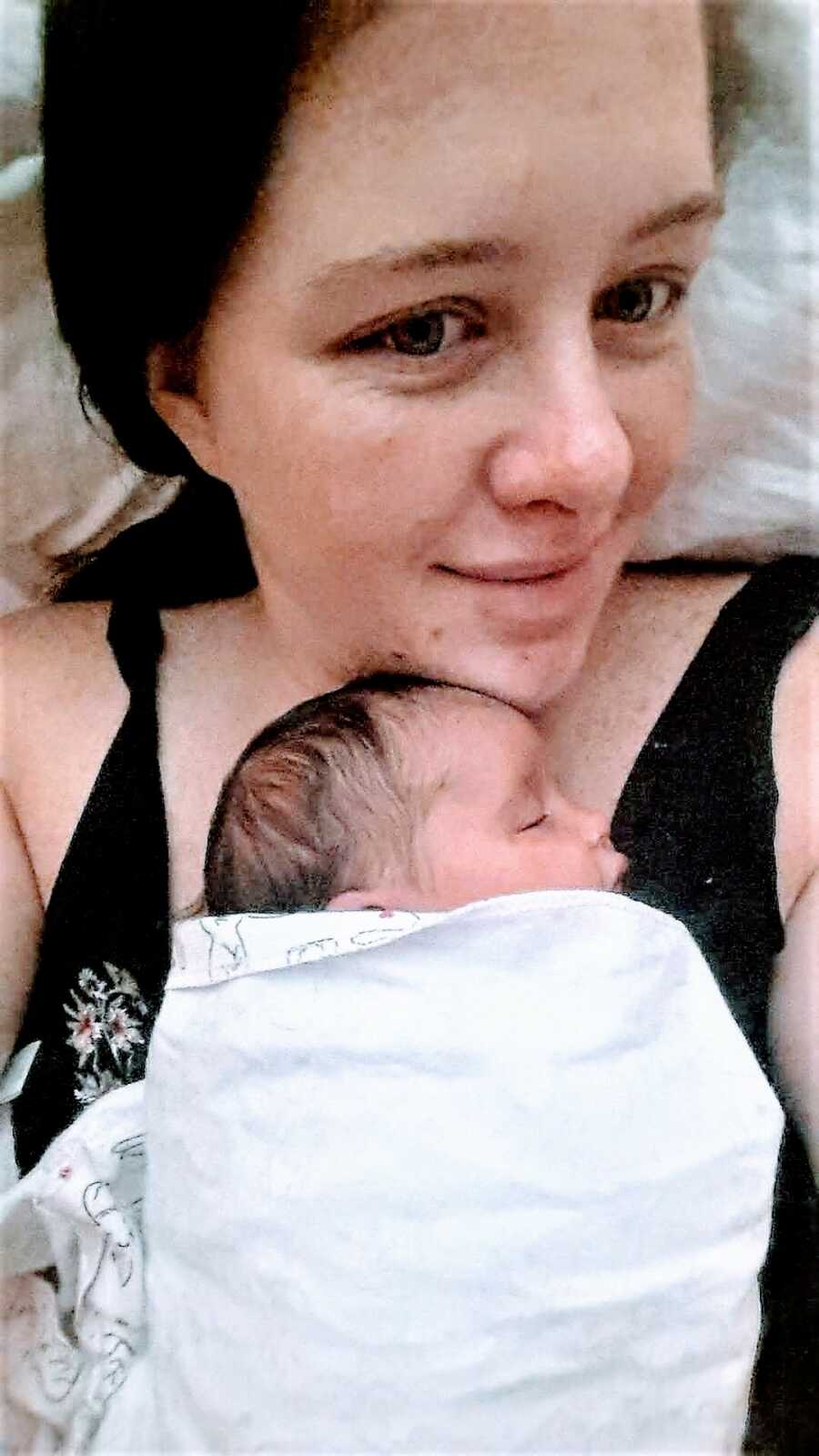 woman holding her baby close