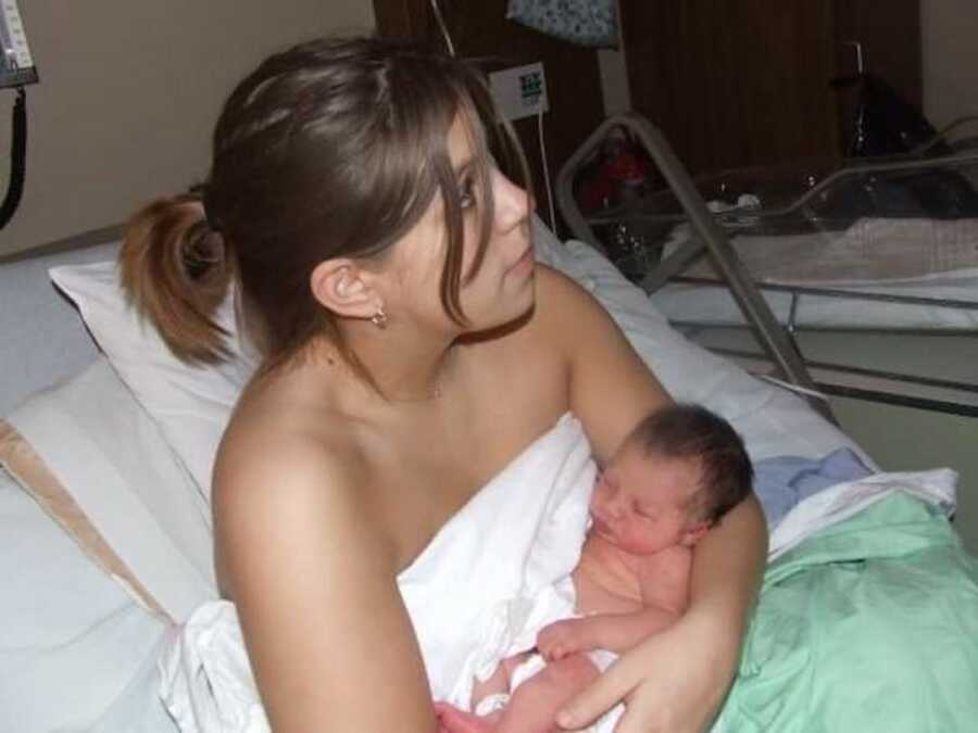 newborn in hospital bed with mother
