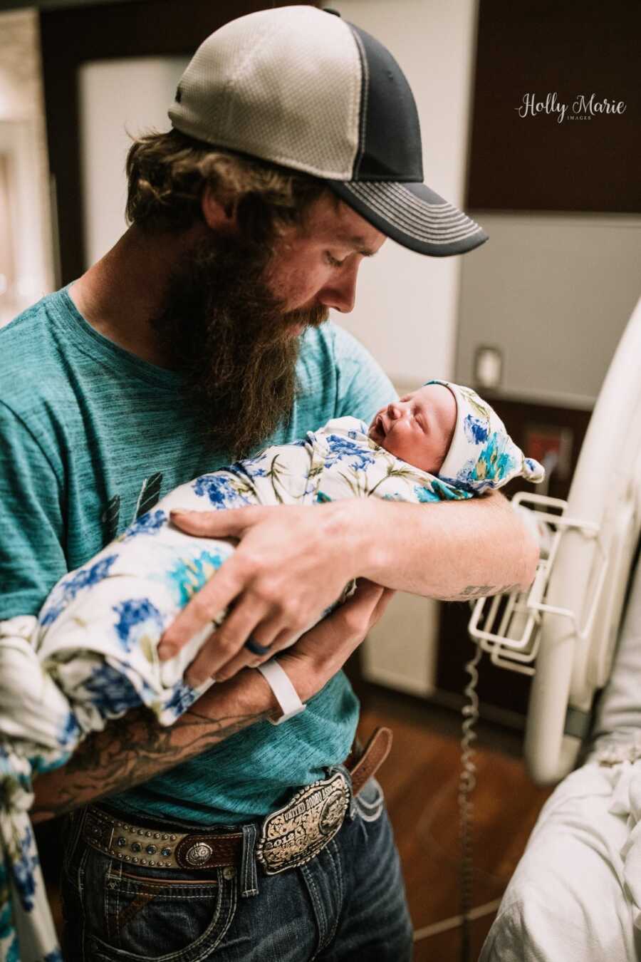 dad holding his newborn son for the first time